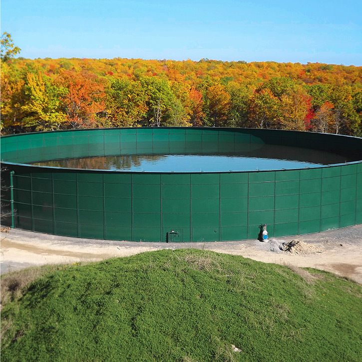 a green industrial liquid storage tank